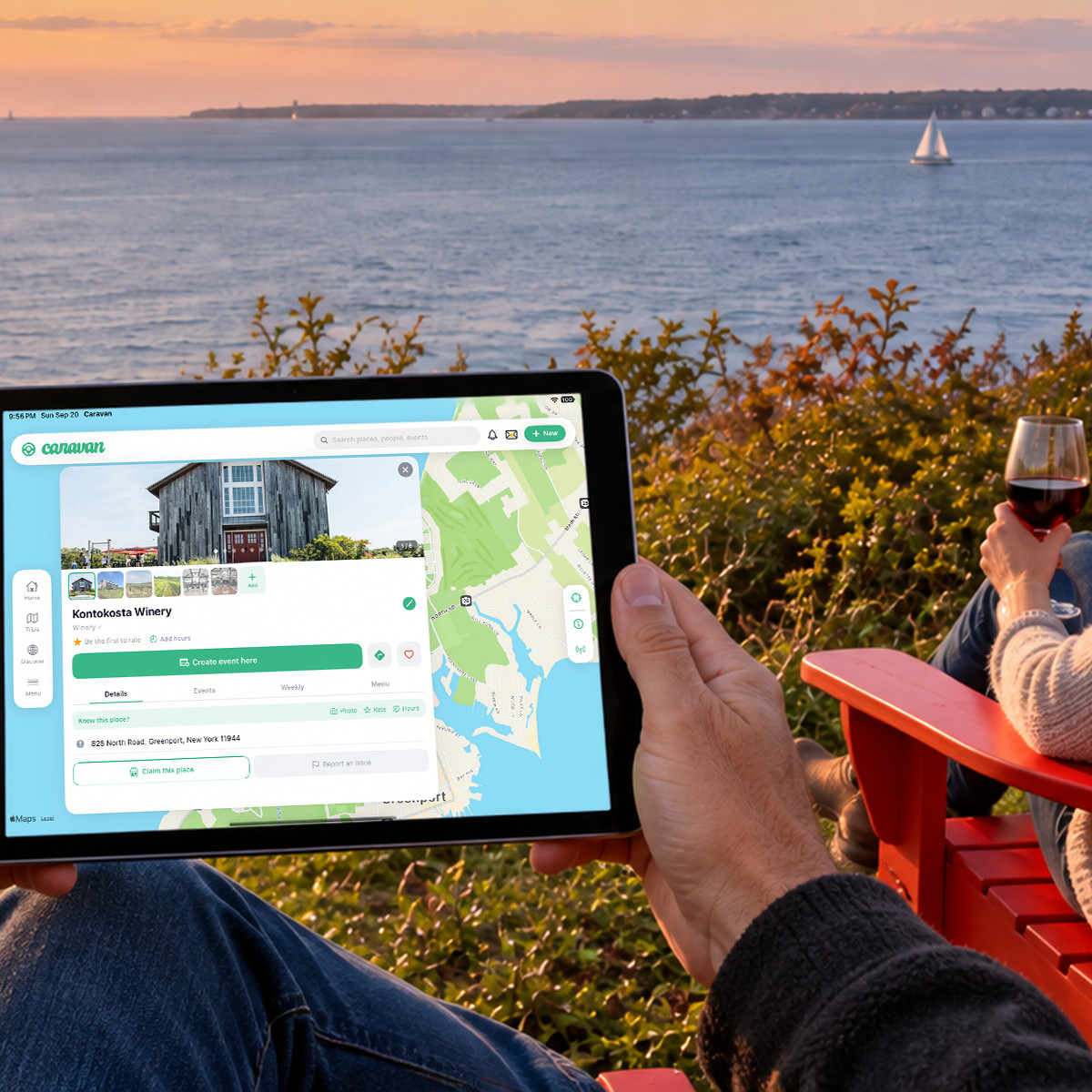 A person on a bluff above the water at sunset holding an iPad: Caravan showing a winery’s place page with photos, address and a Create event here button, beside the map.